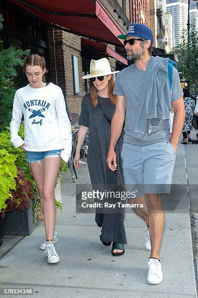 Actresses Liv Freundlich, Julianne Moore, and director Bart Freundlich walk in Tribeca on July 20, 2016 in New York City.