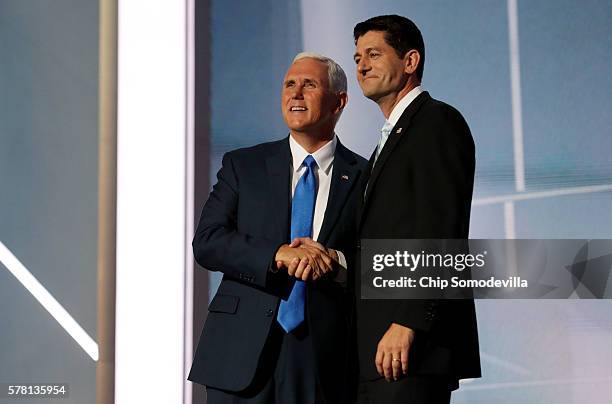 Speaker of the House Paul Ryan shakes the hand of Republican Vice Presidential candidate Mike Pence as he walks on stage to deliver a speech on the...