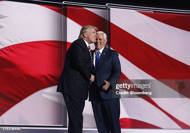 Donald Trump, 2016 Republican presidential nominee, left, kisses Mike Pence, 2016 Republican vice presidential nominee, while on stage during the...