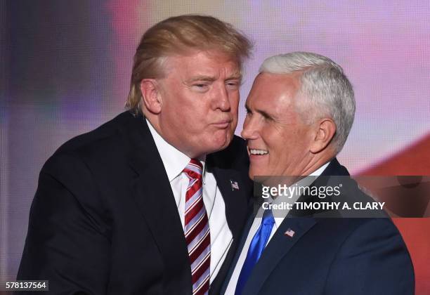 Republican presidential candidate Donald Trump greets vice presidential candidate Mike Pence after his speech on day three of the Republican National...