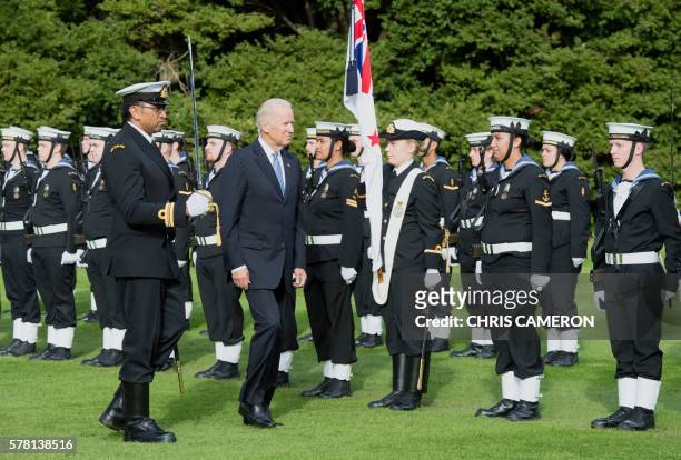 Vice President Joe Biden walks past a guard of honour during a welcoming ceremony at Government House in Auckland on July 21, 2016. Biden is visiting...
