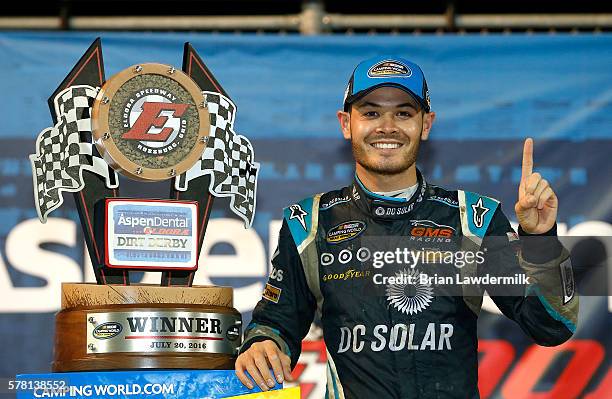 Kyle Larson, driver of the DC Solar Chevrolet, pose with the NASCAR Camping World Series 4th Annual Aspen Dental Eldora Dirt Derby 150 trophey after...