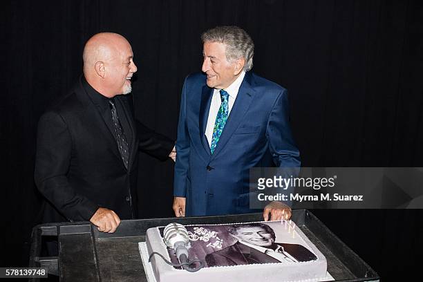 Billy Joel presents Tony Bennett with a cake celebrating his upcoming 90th birthday at Madison Square Garden on July 20, 2016 in New York City.