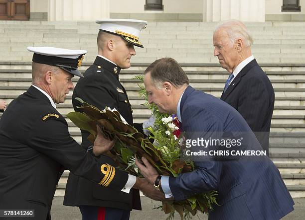 New Zealand Prime Minister John Key and US Vice President Joe Biden take part in a wreath-laying ceremony at the War Memorial in Auckland July 21,...