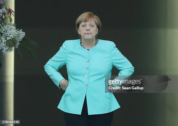German Chancellor Angela Merkel stands in the doorway of the Chancellery as she waits for the arrival of British Prime Minister Theresa May on July...
