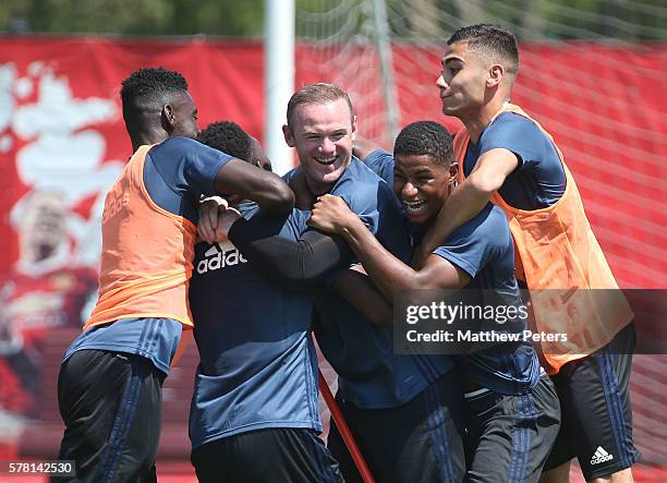 Axel Tuanzebe, Wayne Rooney, Marcus Rashford and Andreas Pereira of Manchester United in action during a first team training session as part of their...