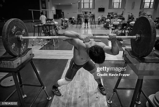 Chinese weightlifter Chen Lijun, who competes in the 62 kg weightclass, prepares to lift during a training session in preparation for the Rio...