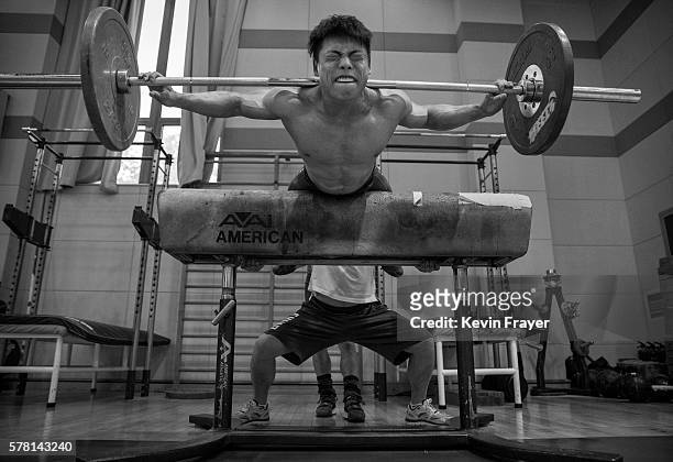 Chinese weightlifter Chen Lijun, who competes in the 62 kg weightclass, exercises with weights during a training session in preparation for the Rio...