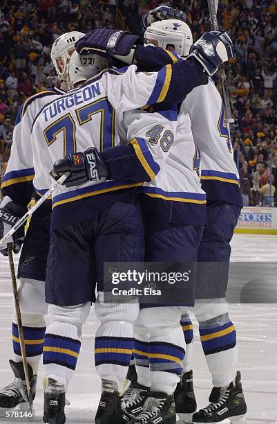 Scott Young of the St. Louis Blues celebrates his goal with teammate Pierre Turgeon during game 1 of the western conference playoffs against the San...