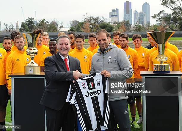 Minister for Sport John Eren is presented with a jersey by Juventus manager Massimiliano Allegri ahead of the club's training session at Lakeside...