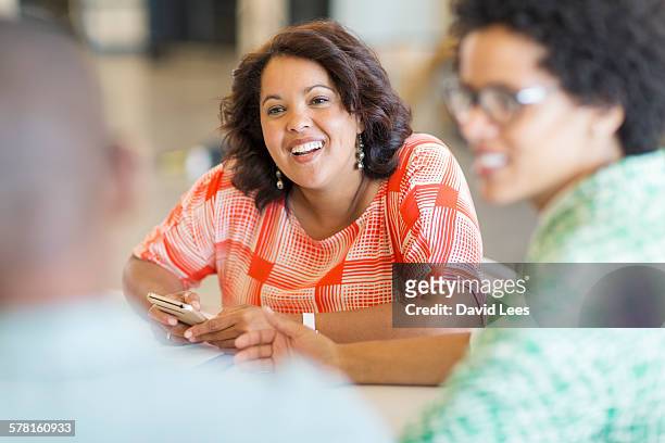 business people talking in meeting in board room - small group of people stock pictures, royalty-free photos & images