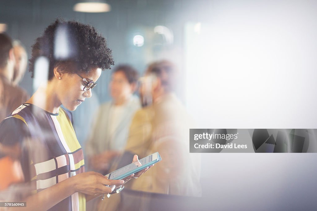 Businesswoman using digital tablet in meeting