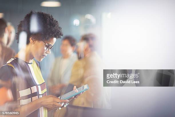 businesswoman using digital tablet in meeting - business people group brown stock pictures, royalty-free photos & images
