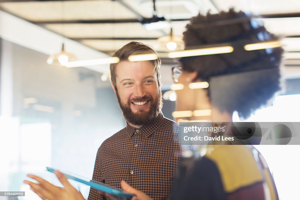 Business people using digital tablet in meeting