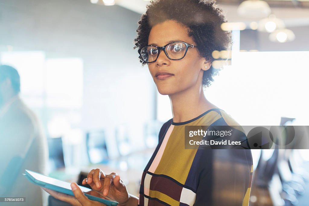 Businesswoman using digital tablet in office