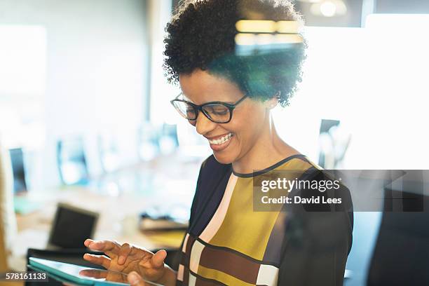 businesswoman using digital tablet in meeting - smart glass stock-fotos und bilder