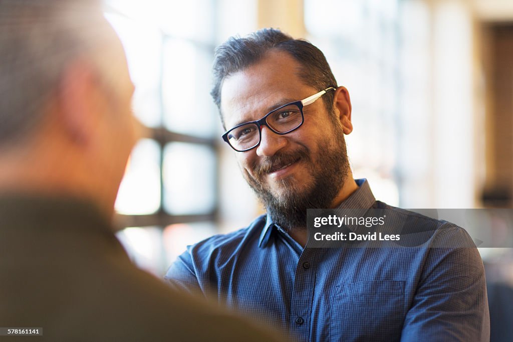 Businessmen talking in office