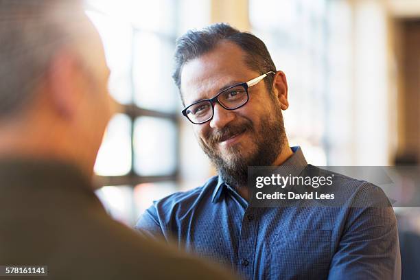 businessmen talking in office - low depth of field photos et images de collection