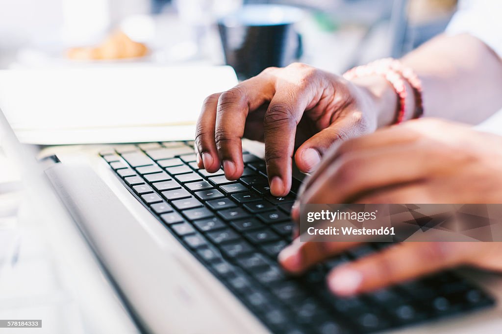 Hands on laptop keybard