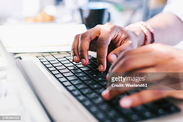 hands on laptop keybard - typing fotografías e imágenes de stock