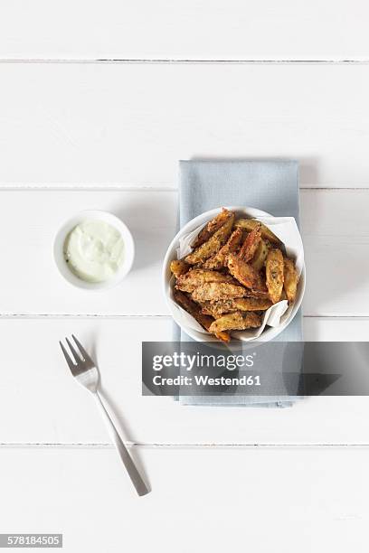 parmesan herbs potato wedges with avodado dip - potato wedges stock pictures, royalty-free photos & images