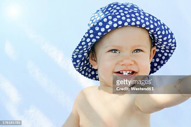 greece, kos, smiling baby girl with sun hat - spotted gum stock pictures, royalty-free photos & images