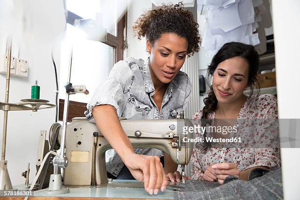 seamstress and fashion designer sewing jacket - sewing machine stock-fotos und bilder