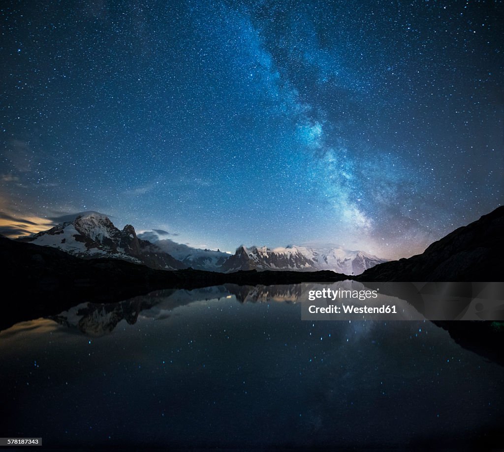France, Mont Blanc, Lake Cheserys, Milky way and Mont Blanc reflected in the lake by night