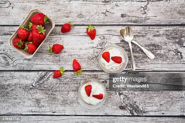 granola, popped amarant, strawberries and yogurt in glasses - amarant stock pictures, royalty-free photos & images