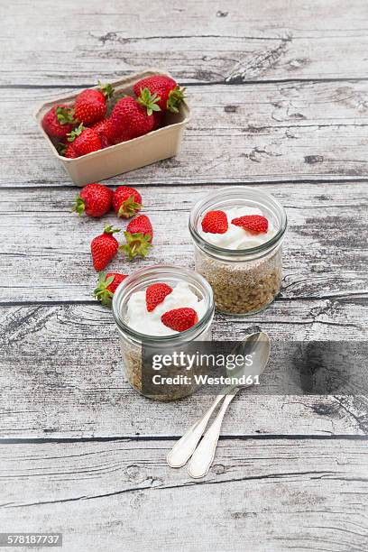 granola, popped amarant, strawberries and yogurt in glasses - amarant stock pictures, royalty-free photos & images