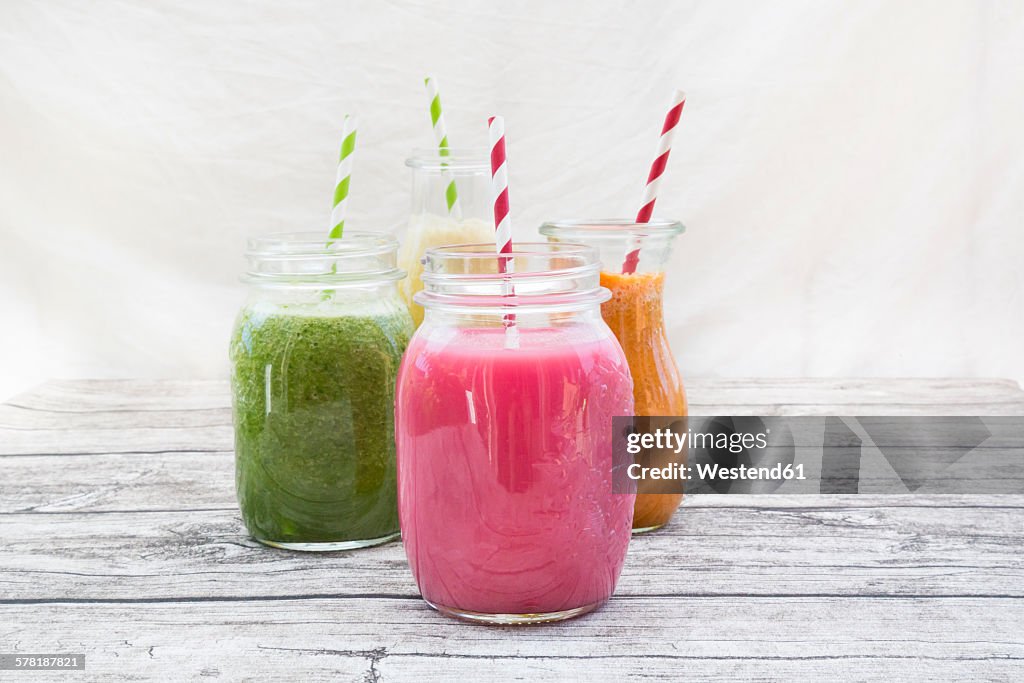 Four glasses of different smoothies