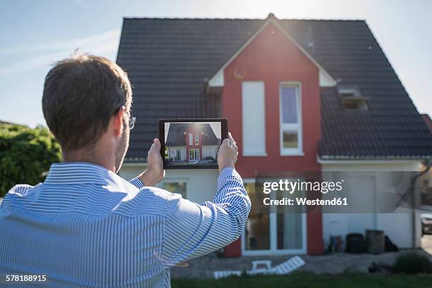 man photographing his house with digital tablet - photographing garden stock pictures, royalty-free photos & images