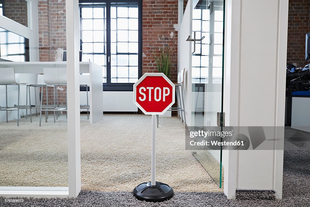 Stop sign in modern open plan office