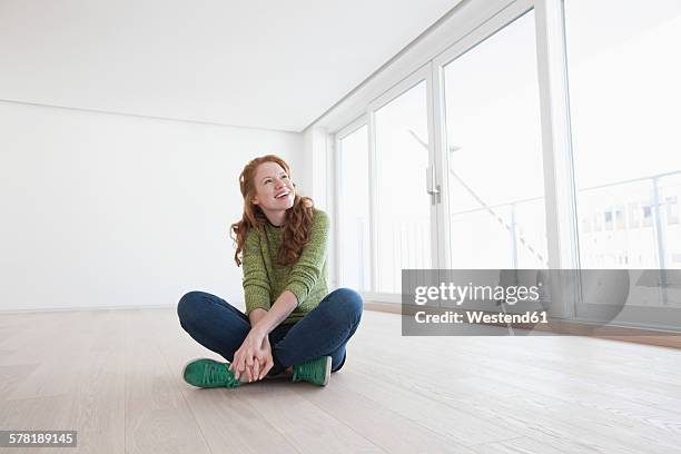 young house-hunting woman viewing modern flat - cross legged stock pictures, royalty-free photos & images