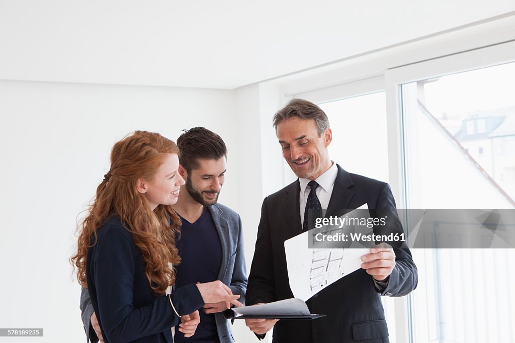 Young couple viewing flat with estate agent