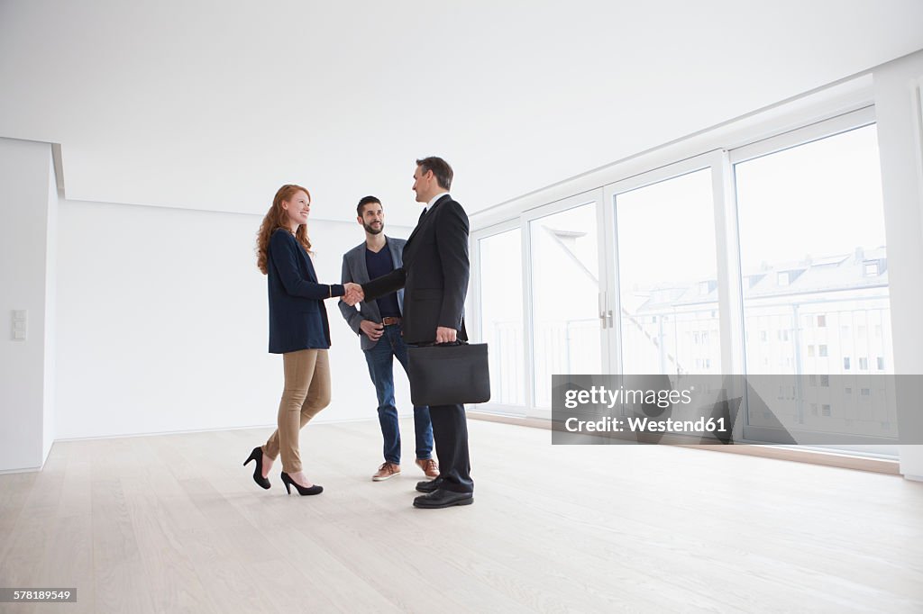 Young couple viewing flat with estate agent