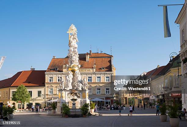 austria, lower austria, baden, plague column on main square - lower austria stock-fotos und bilder