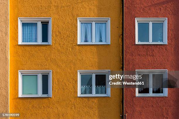 germany, munich, facade and windows of a multi-family house - bavarian man in front of house stock-fotos und bilder