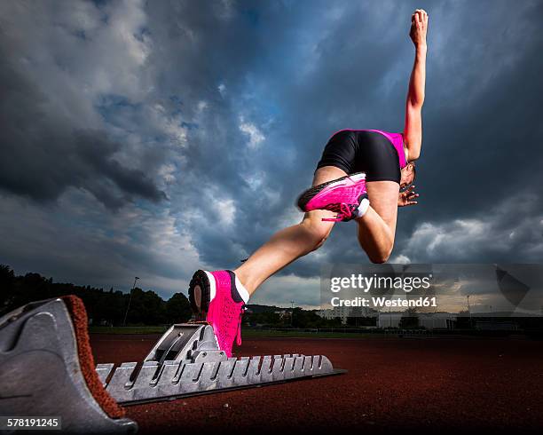 sprinter starting under cloudy sky - start ストックフォトと画像