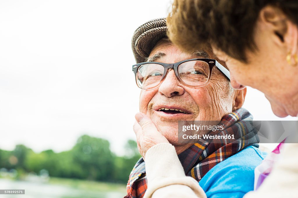 Portrait of happy senior man face to face with his wife
