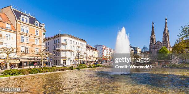 germany, baden-wuerttemberg, baden-baden, augustaplatz, parish church and fountain - baden baden fotografías e imágenes de stock