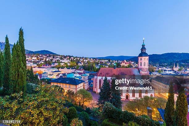 germany, baden-wuerttemberg, baden-baden, cityscape with collegiate church in the evening - baden baden stockfoto's en -beelden