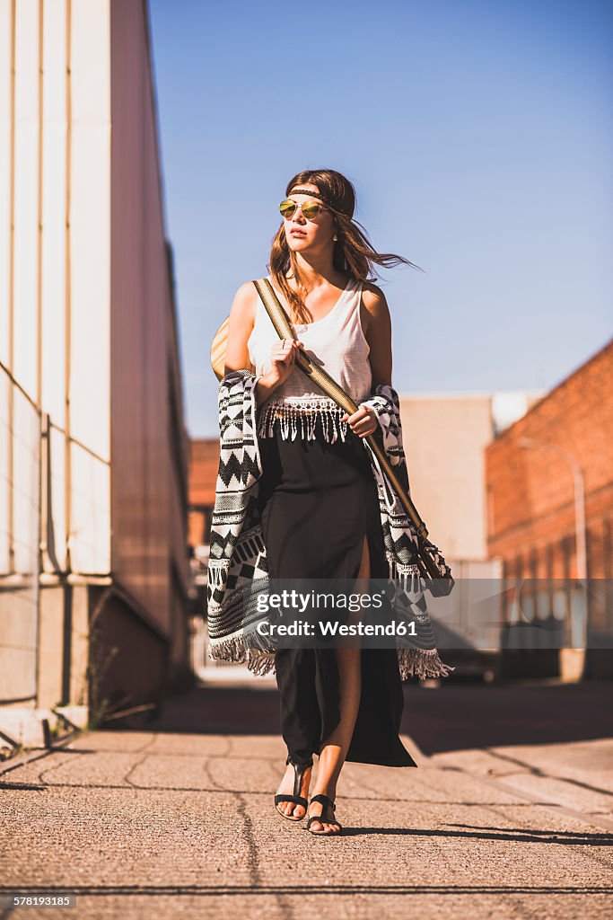 Young woman wearing boho style walking on street