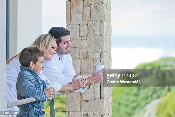 family on patio of beach house - beach house balcony stock pictures, royalty-free photos & images