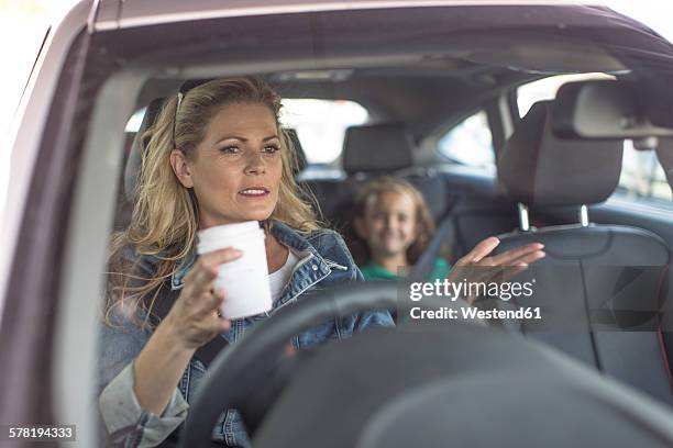 serious woman and girl in car - angry parent mealtime stock pictures, royalty-free photos & images