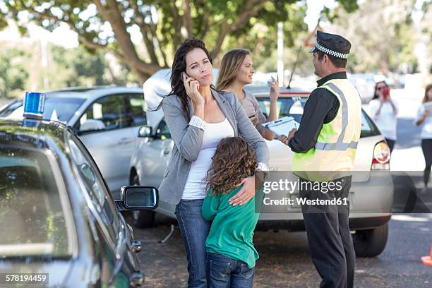 people and policeman at car accident scene - kids call 911 stock pictures, royalty-free photos & images