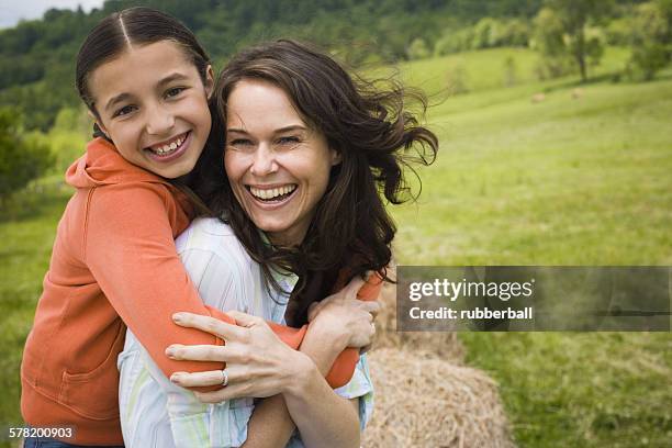 portrait of a girl hugging her mother from behind - chirpy stock pictures, royalty-free photos & images