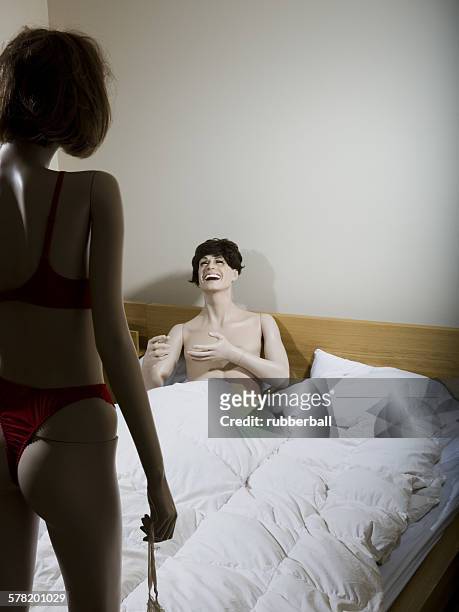 two mannequins portraying a heterosexual couple in the bedroom - futurista stock pictures, royalty-free photos & images