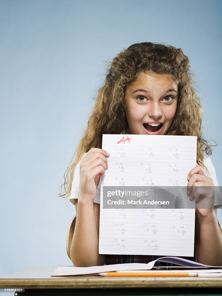 Schoolgirl holding A plus paper