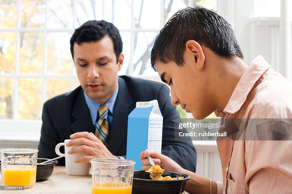 Man and boy at breakfast table displeased